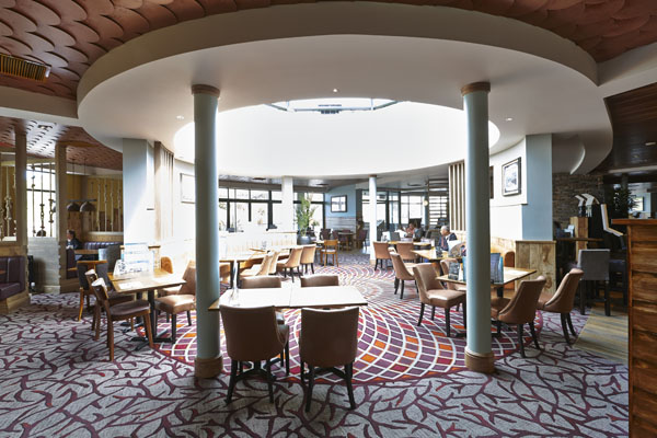 Admiral Collingwood Wetherspoon seating area with red and orange spiral patterns, designed bespoke by Wilton Carpets