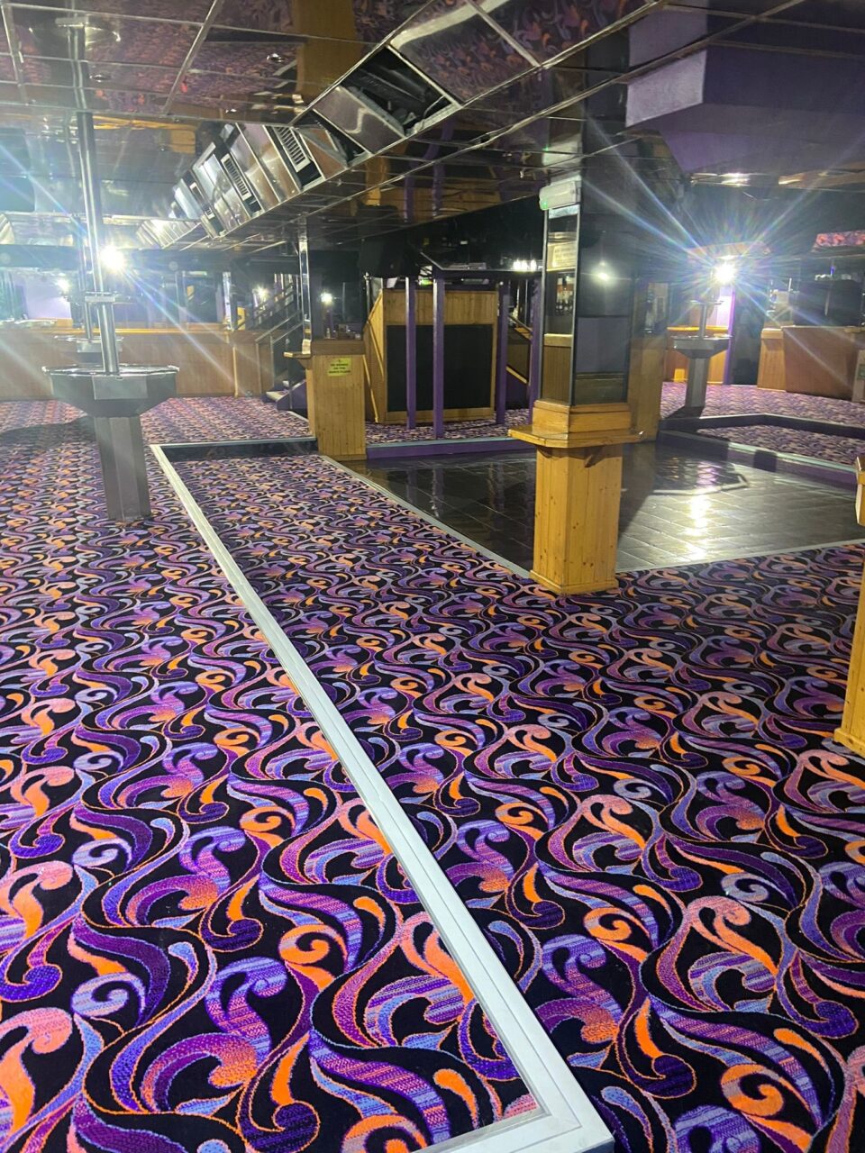 Wide shot of Acapulco Nightclub Halifax dance floor with bespoke purple and black patterned carpets designed by Wilton Carpets