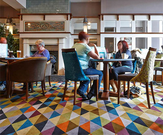 A multicoloured restaurant carpet with a triangular design