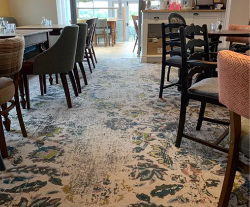 A restaurant carpet designed with leaves and floral patterns