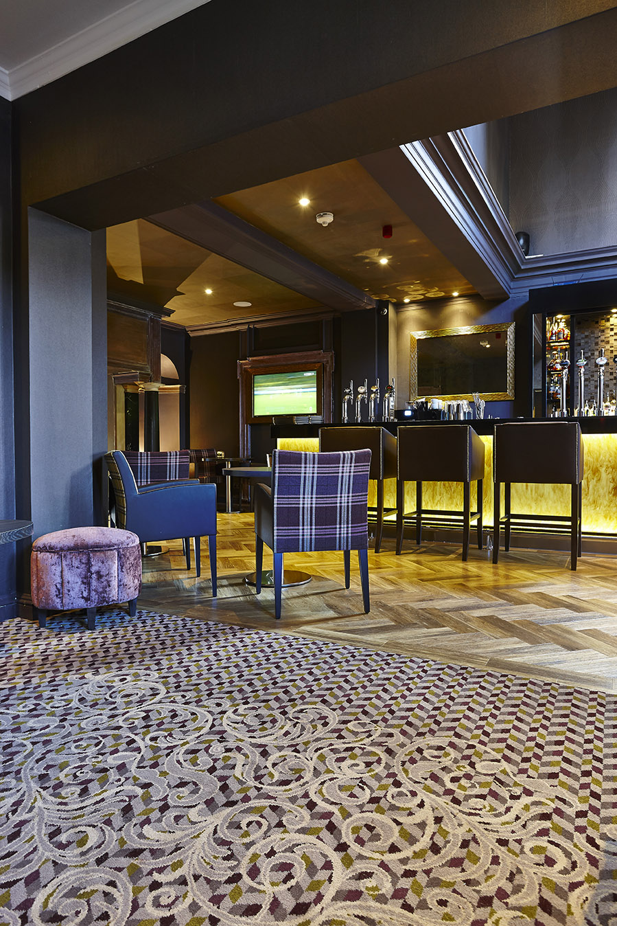 Abbey House Hotel bespoke bar carpet, with grey and cream floral patterns, designed by Wilton Carpets