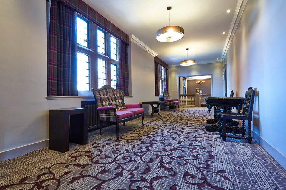 Abbey House Hotel corridor, with a grey and cream striped carpet, designed bespoke by Wilton Carpets