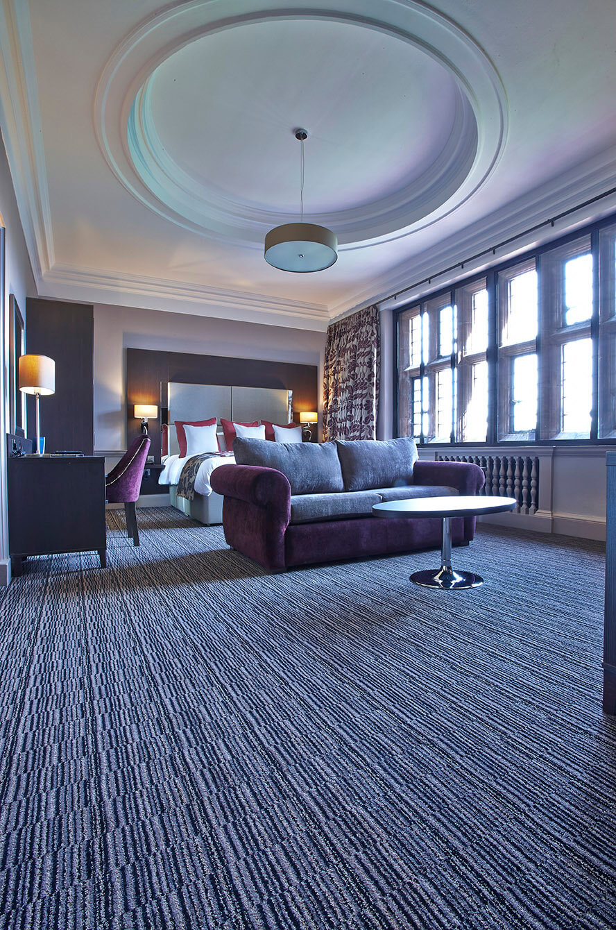 Abbey House Hotel private bedroom, with a black, grey and cream striped carpet, designed by Wilton Carpets