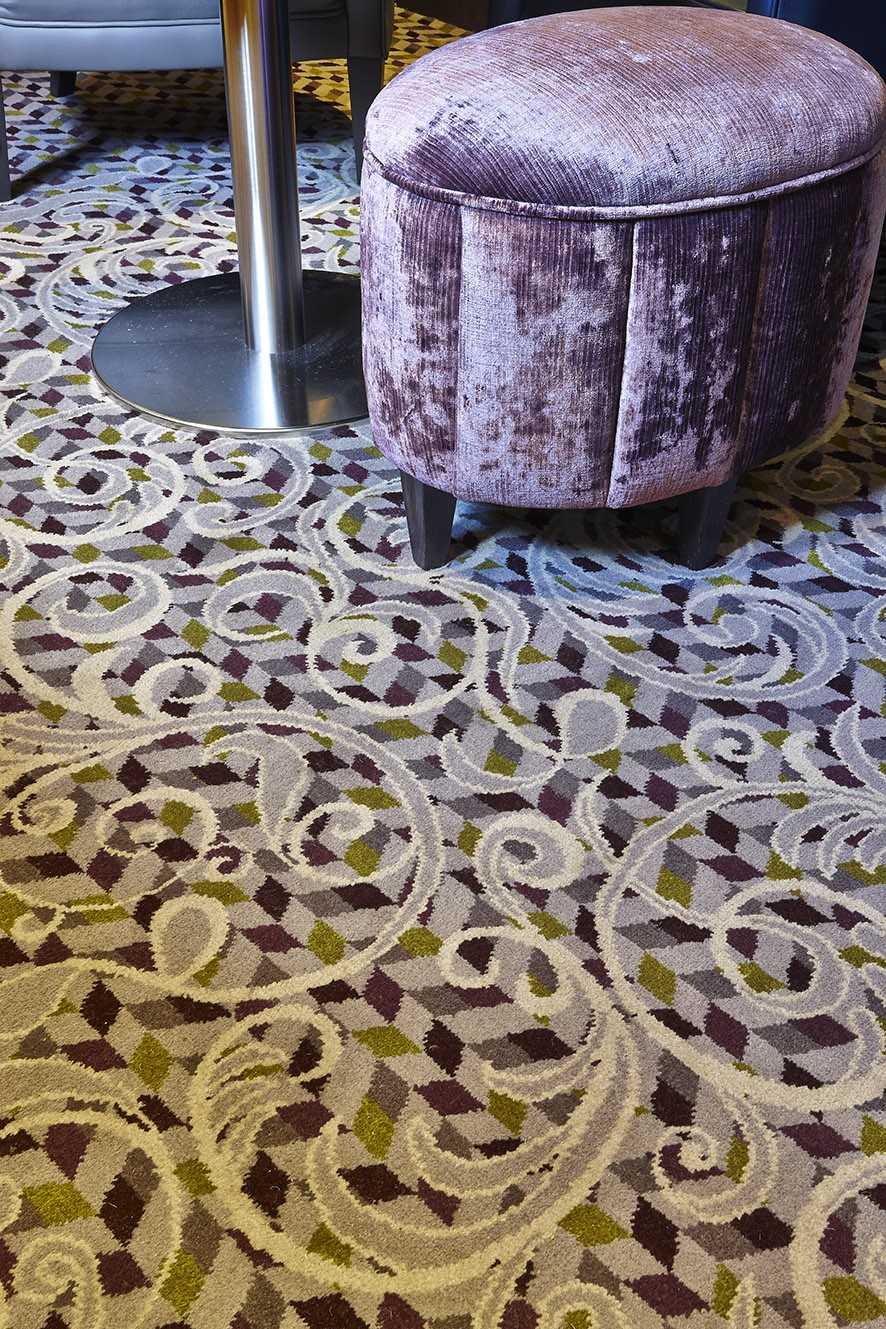 Close up shot of Abbey House Hotel bespoke sitting area carpet, with grey and cream floral patterns, designed by Wilton Carpets