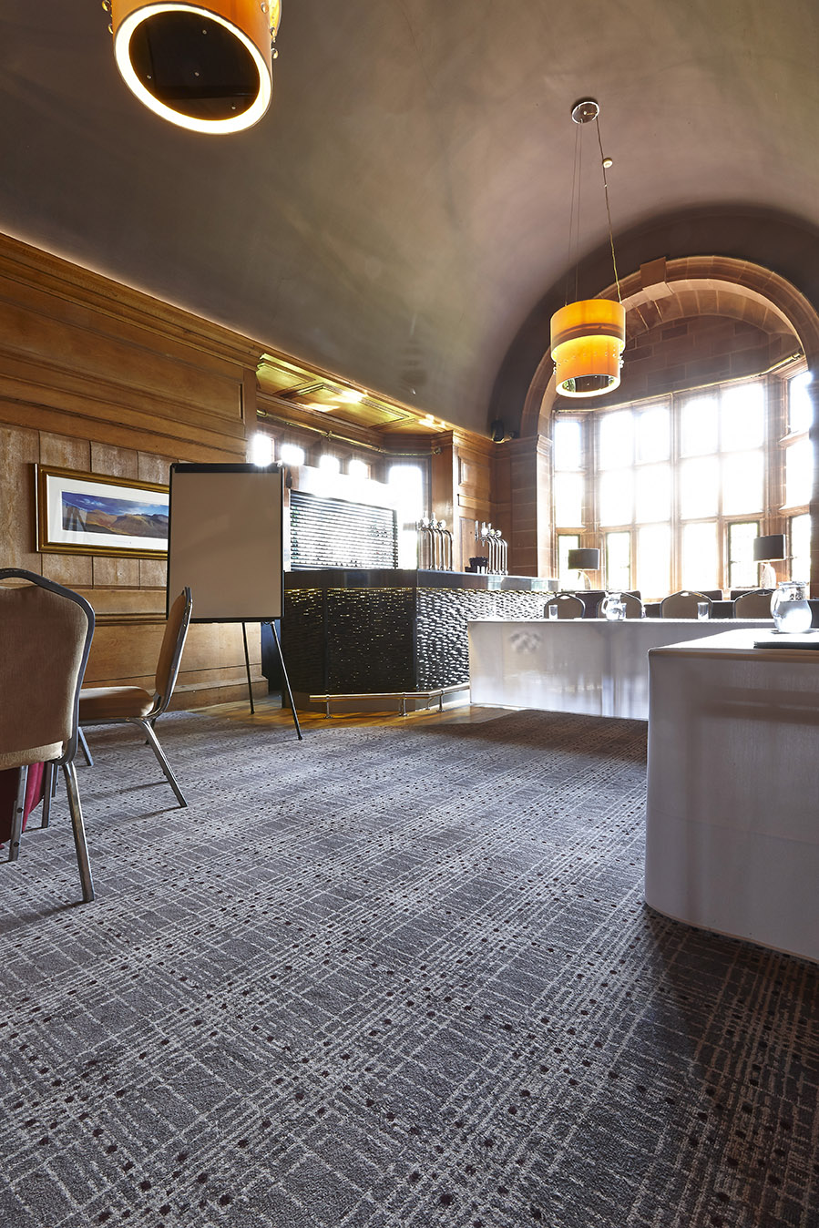 Close up shot of Abbey House Hotel bespoke bar carpet, with grey and cream strips, designed by Wilton Carpets