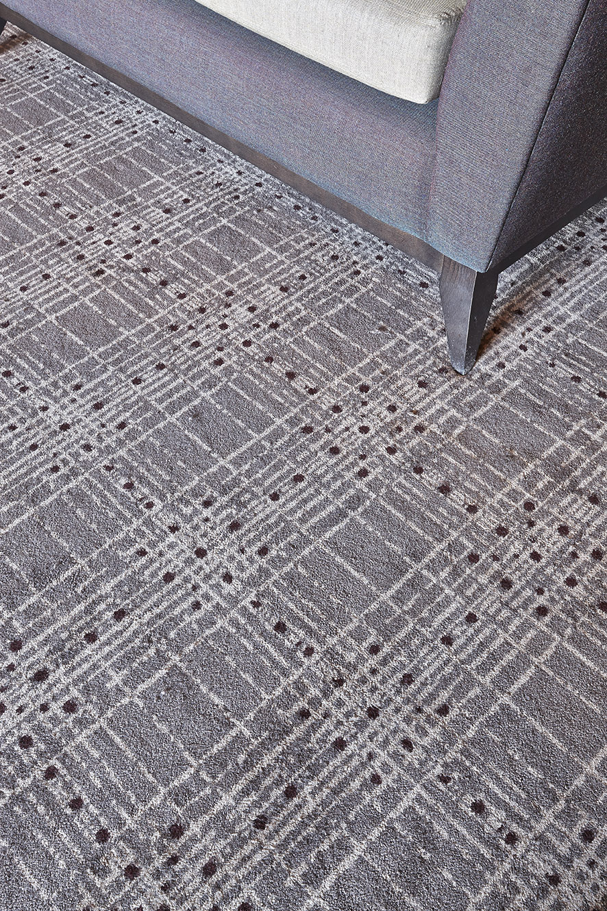 Close up shot of Abbey House Hotel bespoke lounge area carpet, with grey and cream strips, designed by Wilton Carpets